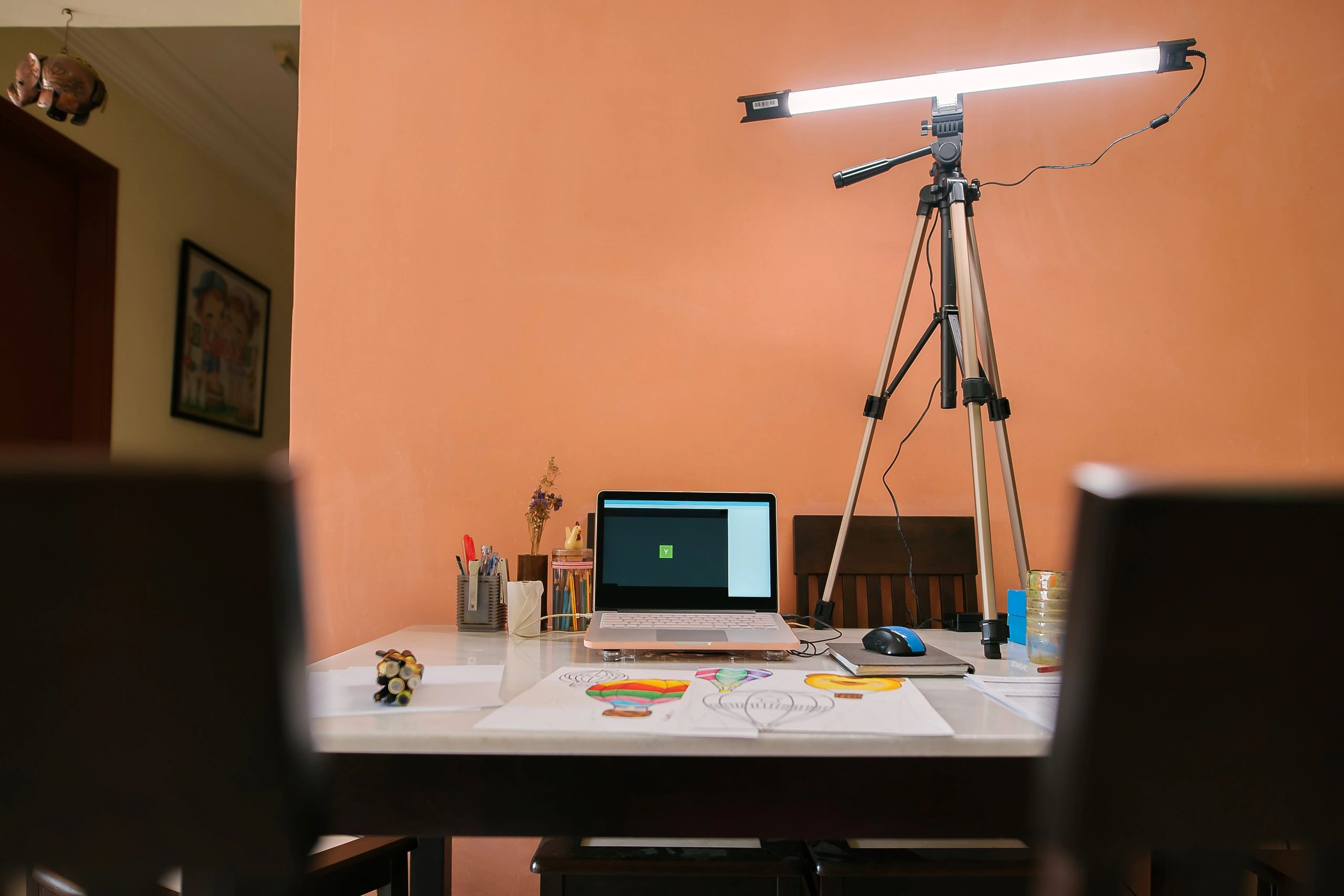 Creative workspace with laptop and art tools